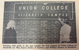 Students pointing to the Union College Elizabeth Campus sign outside the new campus in Elizabeth, New Jersey in 1970.