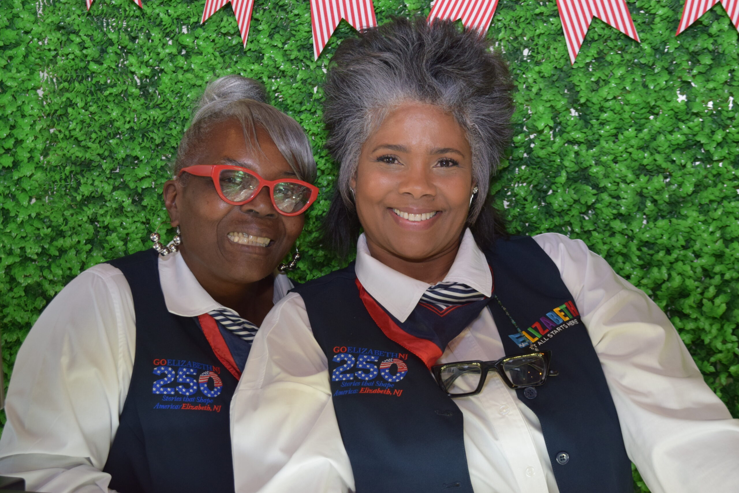 elizabeth-tour-ambassadors-welcome-station-grand-opening Two Elizabeth Tour Ambassadors smile in uniform during the Welcome Station grand opening in Elizabeth NJ.