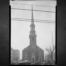 Black-and-white 1936 east view of First Presbyterian Church in Elizabeth with its tall clock tower and cars parked along Broad Street.