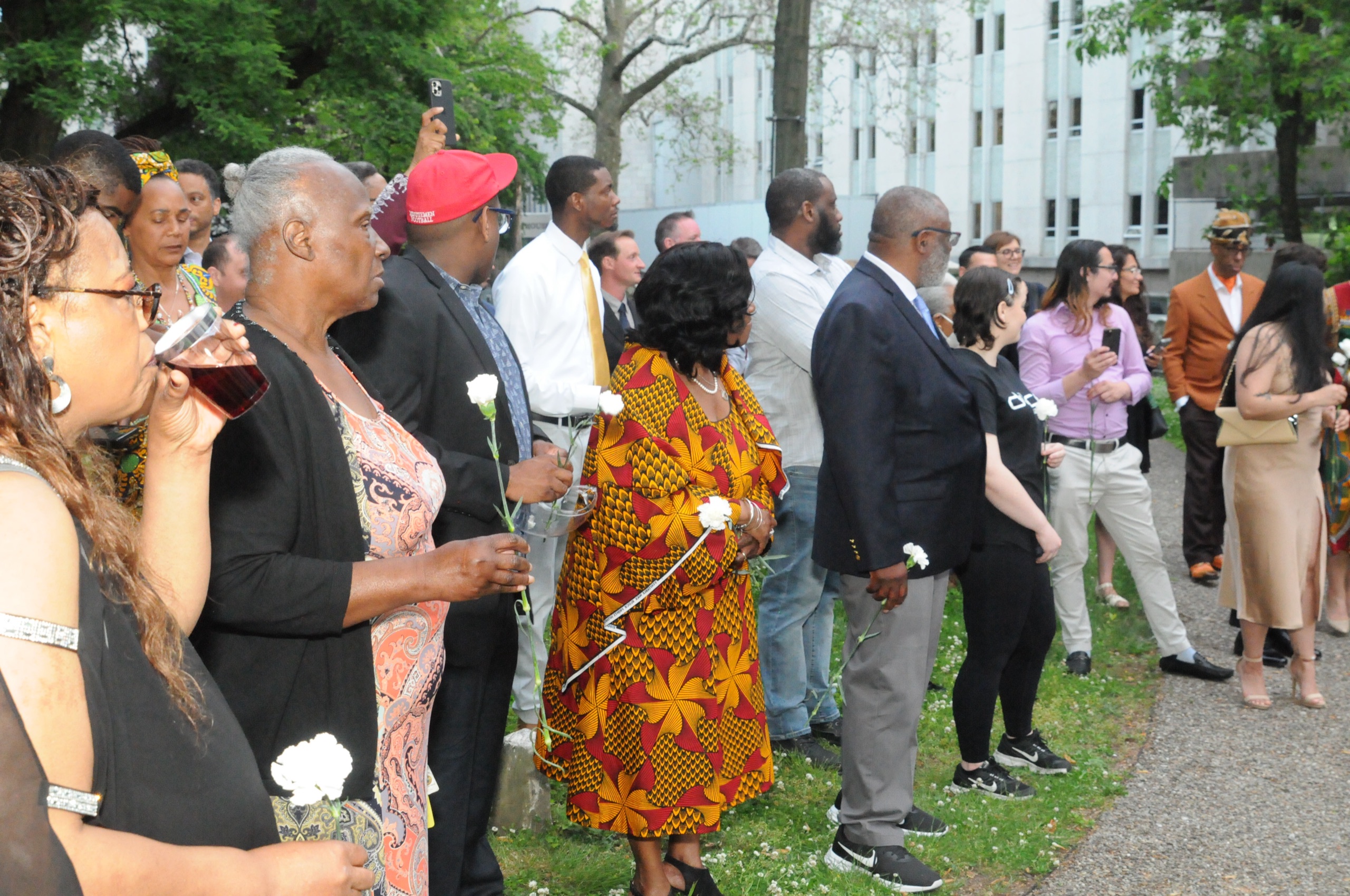 Attendees gather around the then-unfinished 313+ Ancestors Speak Monument during a 2022 ceremony.