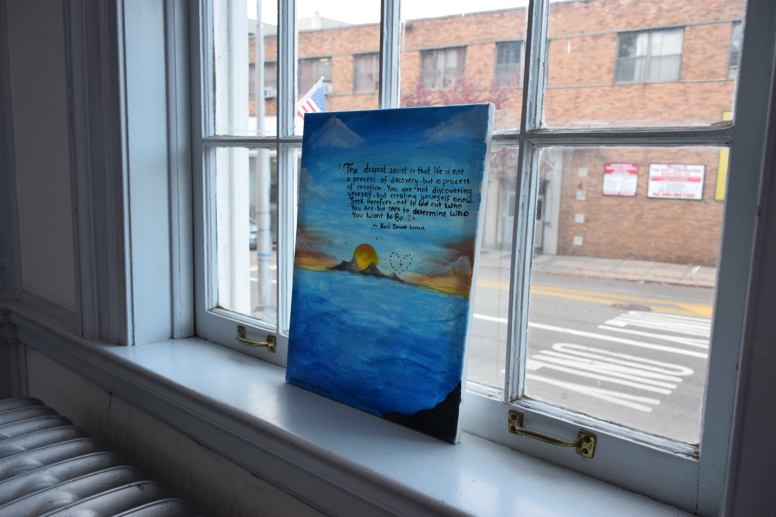 Artwork displayed in a Snyder Academy window during Journey to Love 2024.