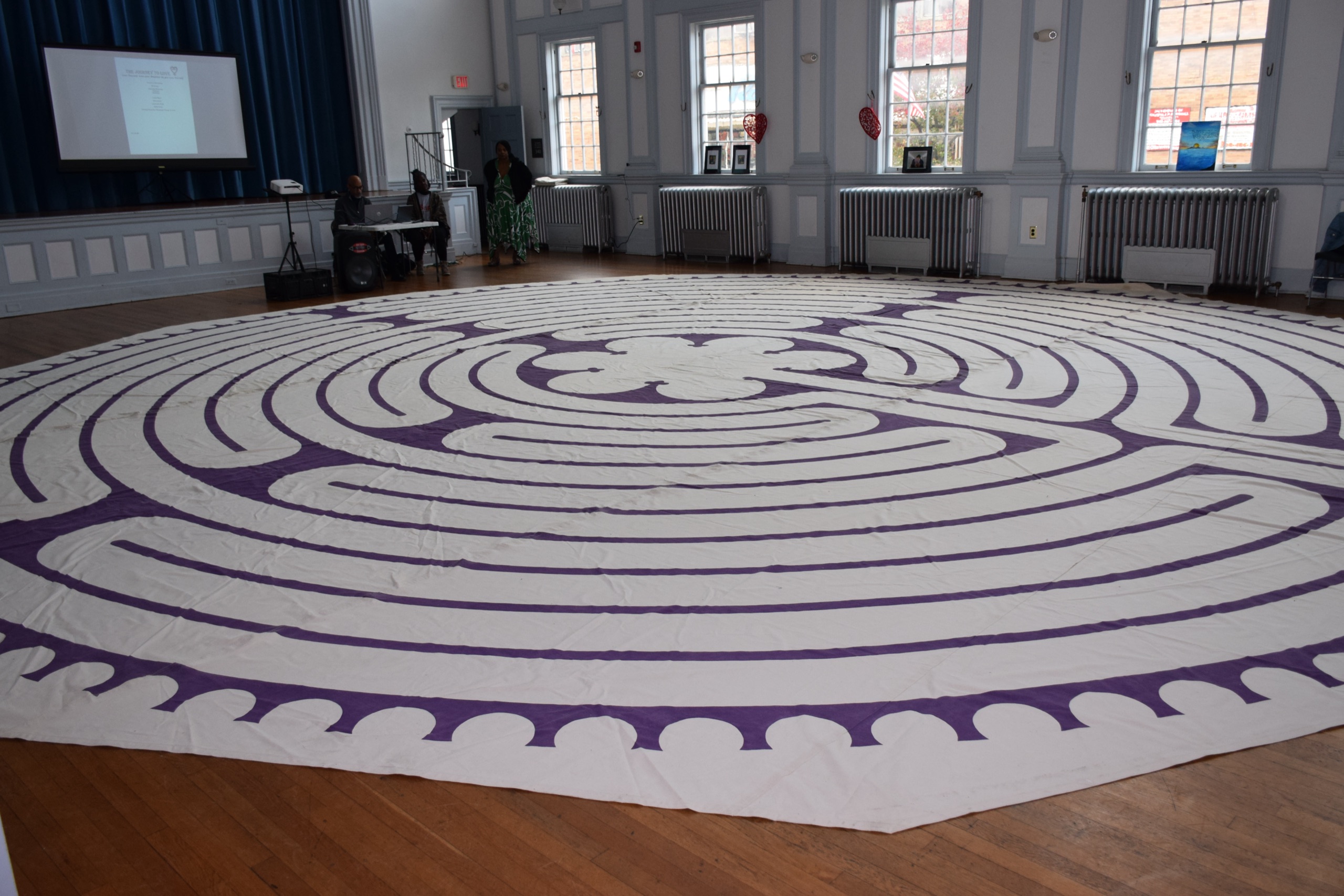 Large labyrinth-style floor installation in the Snyder Academy hall during Journey to Love 2024.