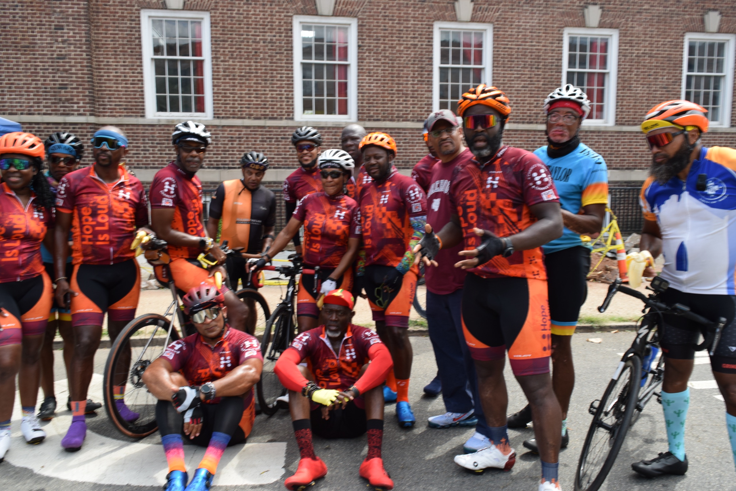 Cyclists pose outside Snyder Academy during Hope Is Loud in 2022.