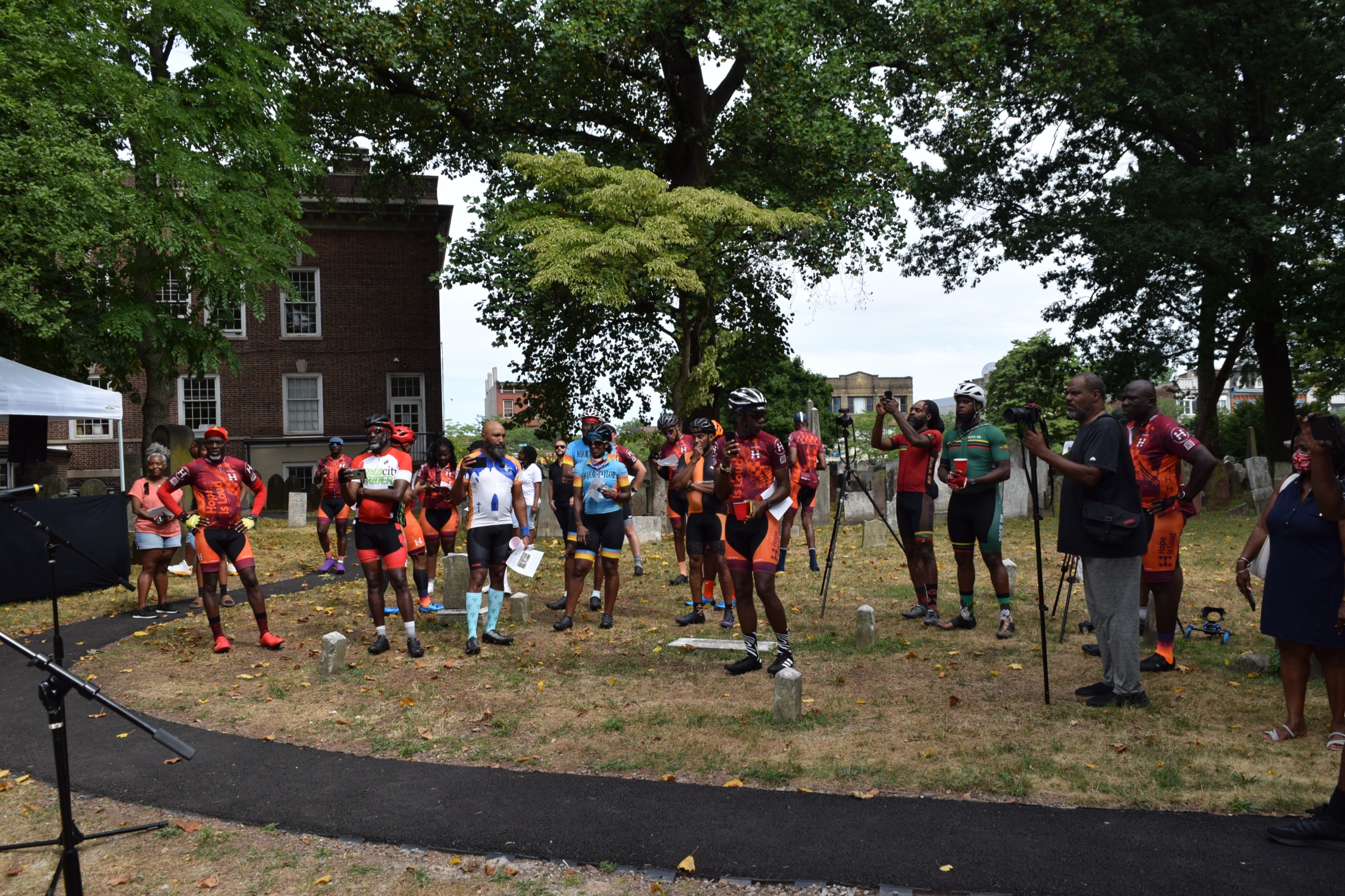 Cyclists visit the historic burial grounds beside Snyder Academy during Hope Is Loud in 2022.